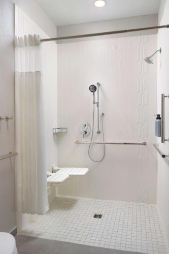 a white bathroom with a shower and a sink at Courtyard by Marriott Birmingham Grandview in Birmingham