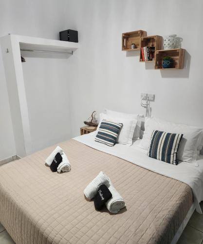 a bedroom with a large bed with two pillows at Kato Yialos Paros in Parikia