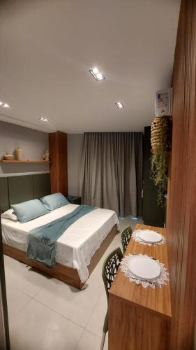 a bedroom with a bed and a table with chairs at Ancorar Hospedagens in João Pessoa