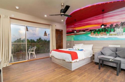 a bedroom with a bed and a large window at Ukulhas Villa Hotel & Spa in Ukulhas
