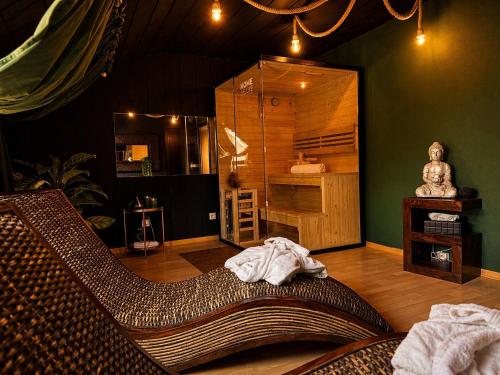 a living room with a couch in a room with a room at Emotion Apartments- BDSM Apartment mit privater Sauna in Vlotho