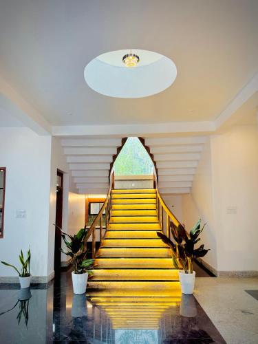 a staircase in a building with potted plants at Kings Castle in Varkala