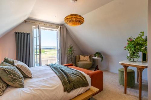 a bedroom with a bed and a window and a chair at Cedar Lodge Severn Stoke in Severn Stoke