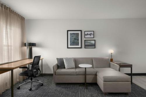 a living room with a couch and a desk at Residence Inn Boise West in Boise