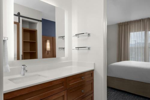 a bathroom with a sink and a bed at Residence Inn Boise West in Boise