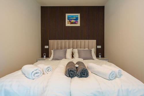a large white bed with towels on it at Apartman Mirakul 2 in Korčula