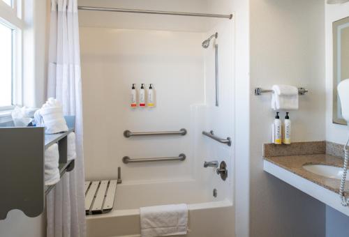 a bathroom with a shower and a sink at Sand Castle Inn in Seaside