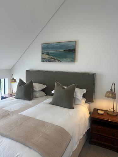 a bedroom with two beds with white sheets at St Francis Links- Gallery Deck Links Villas in St Francis Bay