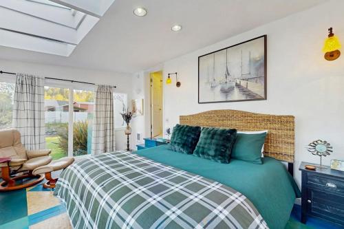 a bedroom with a bed and a chair at Eagle Harbor House World Cup Availability in Winslow
