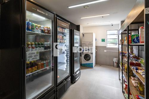 a kitchen with a refrigerator and a washing machine at Lobie Botafogo Privilege in Rio de Janeiro