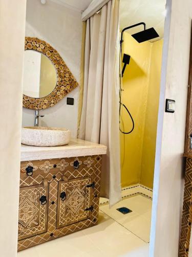 a bathroom with a sink and a mirror at Camp Merzouga Sand Explorer in Merzouga