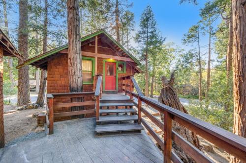 a cabin in the woods with a staircase to the front door at Idyllwild Glory Days in Idyllwild