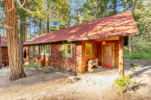 a small house with a dog sitting outside of it at Idyllwild Glory Days in Idyllwild