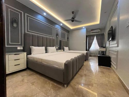 a bedroom with a large bed in a room at Seaview lodge Executive in Karachi