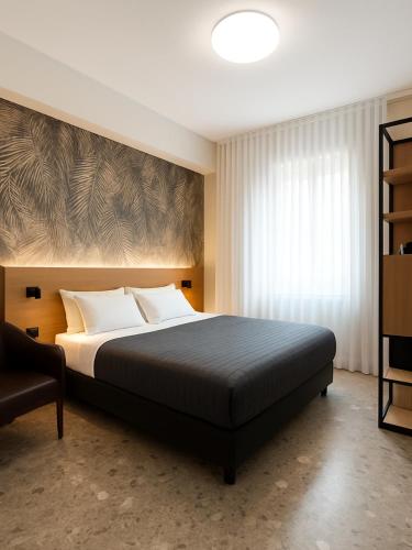 a bedroom with a large bed and a window at Hotel Miramare in Sottomarina