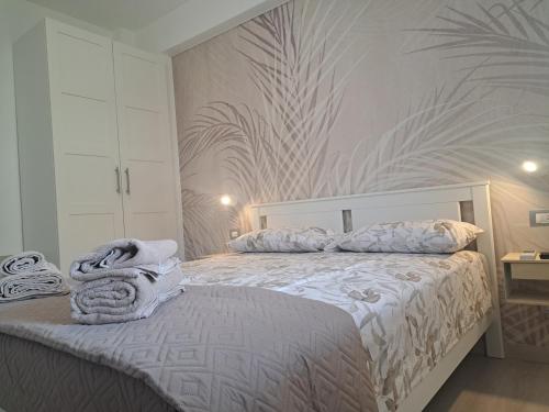 a bedroom with a bed with towels on it at Brezza d'amare a lovely accommodation in Anzio in Anzio