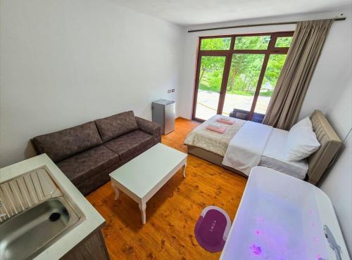 a living room with a couch and a sink at Arditis Cozy Studio in Bogë