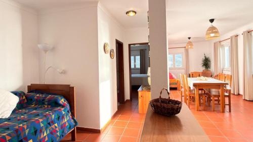 a living room with a bed and a dining room at Apartamento sto estavão 2 in Zambujeira do Mar