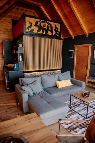 a living room with a couch and a painting on the wall at Mountain Dream Chalet Durmitor in Nedajno