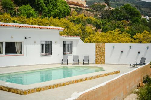 a villa with a swimming pool on a hill at Finca Tres Aguas, Casa Rural con Piscina Privada in Lanjarón