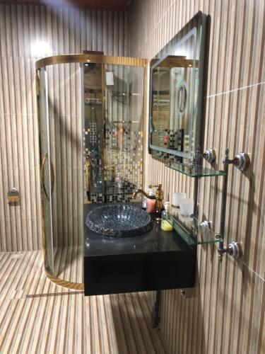 a bathroom with a sink and a mirror at Zions Apartments in Elephant Island