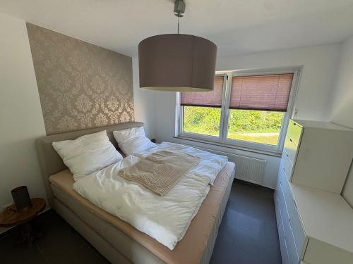 a small bed in a room with a window at Traum Ferienwohnung Kell am See in Kell
