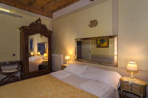 En eller flere senge i et værelse på Al Tuscany B&B