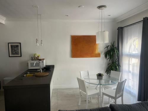 a kitchen and dining room with a table and chairs at Knickerbocker 102 in Miami Beach