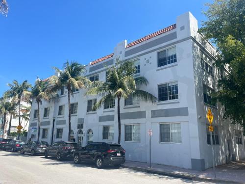 a white building with cars parked in front of it at Knickerbocker 102 in Miami Beach