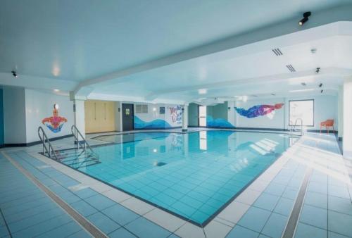 a large swimming pool in a large building at Aurora Beacon View in Lossiemouth