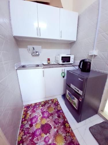 a kitchen with a sink and a kitchen rug at Easy Stay in Al Ain