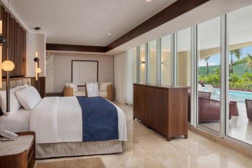 a bedroom with a large bed and a balcony at Moon Palace The Grand Cancun All Inclusive in Cancún