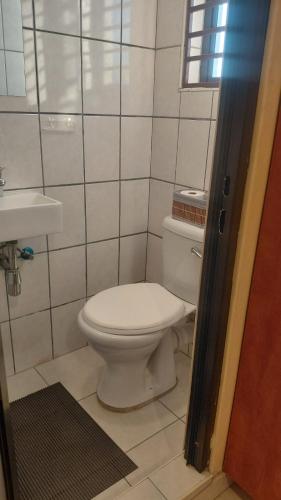 a bathroom with a toilet and a sink at Hyponia 1512 in Oshikuku