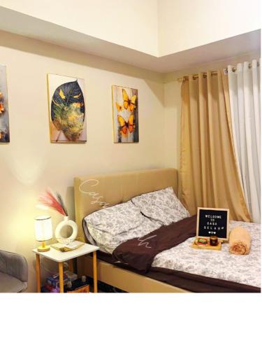 a bedroom with a bed with a laptop on it at Aurora Escalades in Manila