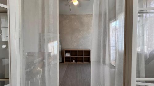a room with a window and a white curtain at CASA LOOL BEH in San Miguel de Allende