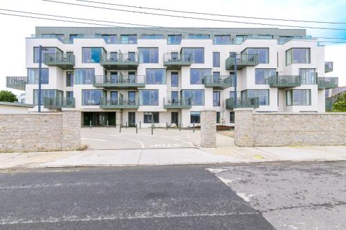 a white building with blue windows and a street at Apex Executive Apartments - The Lookout in Dublin