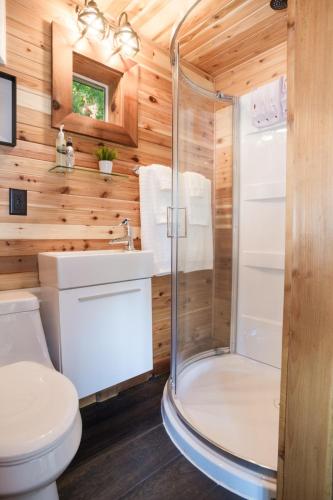 a bathroom with a shower and a toilet at Owl's Perch Treehouse in Sooke