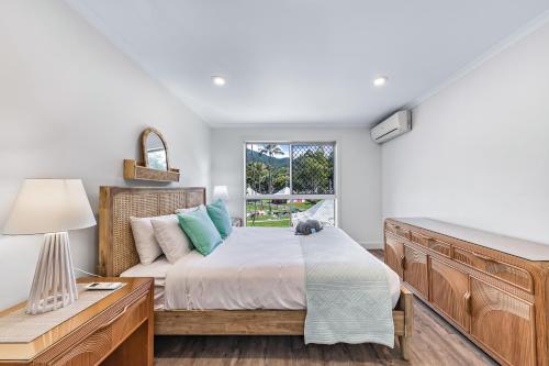 a bedroom with a bed and a window at Blue Lagoon Airlie Beach in Airlie Beach