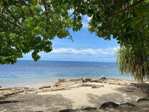 a beach with a view of the ocean at Tahiti Sunrise Beach in Vaitoare