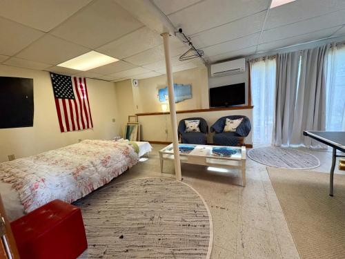 a bedroom with a bed and an american flag at The Purple Room with private bath in Narragansett