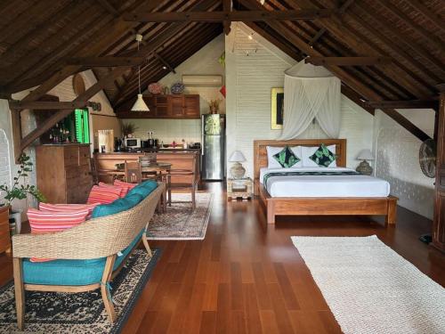 a bedroom with a bed and a kitchen in a room at The Papas Villas in Tegalalang