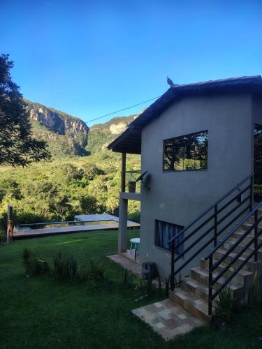 a house with a staircase leading up to it at Chale2RabodeGalo in Santana do Riacho