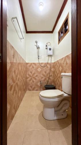 a bathroom with a toilet and a shower at Sequor Palm Villa in Siquijor