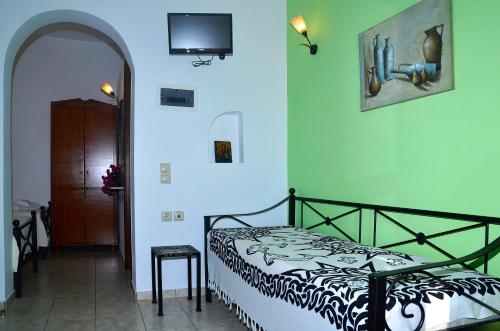 a bedroom with a bed with a black and white comforter at Onar Studios in Koufonisia