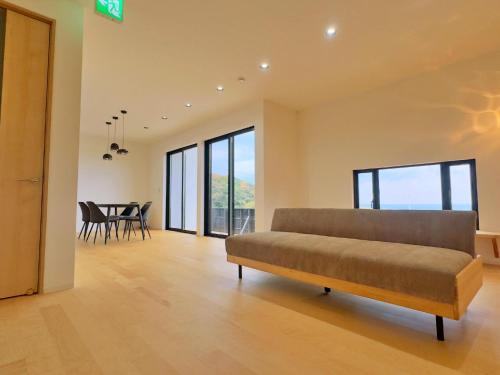 a living room with a couch and a dining room at Private Villa 蒼 Lala & Lino in Kyotango