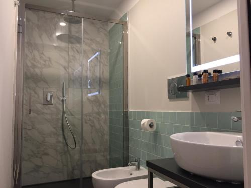 a bathroom with a shower and a sink and a toilet at Vittoriano Suite in Rome