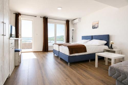 a bedroom with a bed and a large window at Nastov Apartments in Veles