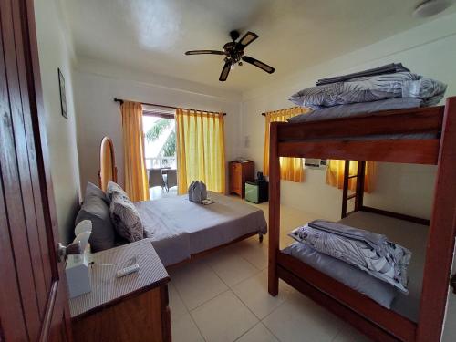 a bedroom with two bunk beds and a window at Anton's Beach Resort in Oslob