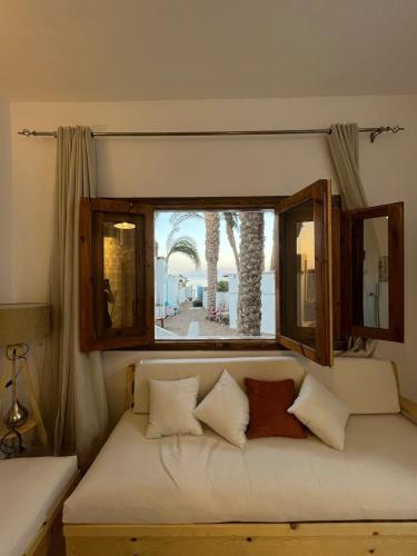 a couch in a room with a window at Oia seafront house in Dahab