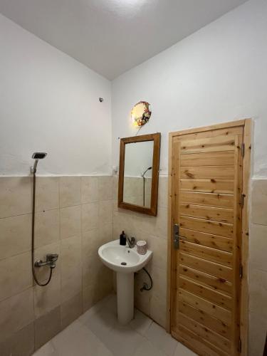 a bathroom with a sink and a mirror at Oia seafront house in Dahab